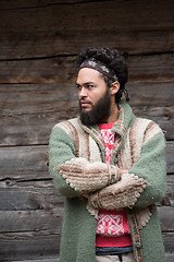 Image showing portrait of young hipster in front of wooden house