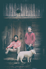 Image showing frineds together in front of old wooden house