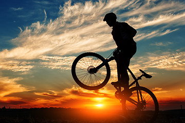 Image showing Silhouette of a man on muontain-bike