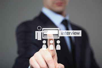 Image showing business, technology and internet concept - businessman pressing interview button on virtual screens