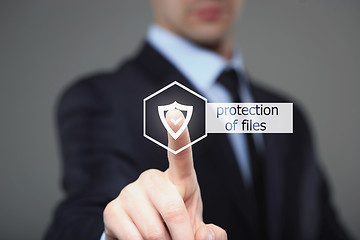 Image showing  technology and internet concept - businessman pressing security button on virtual screens. protection of files