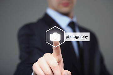 Image showing Close up of businessman touching camera icon on media screen