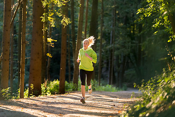 Image showing Pretty young girl runner in the forest. 