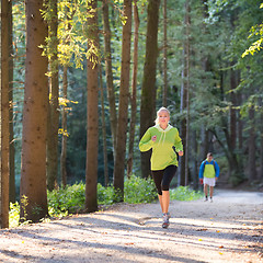 Image showing Pretty young girl runner in the forest. 