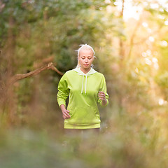 Image showing Pretty young girl runner in the forest. 