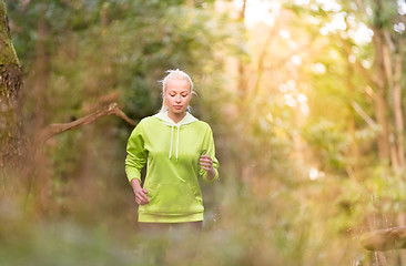 Image showing Pretty young girl runner in the forest. 