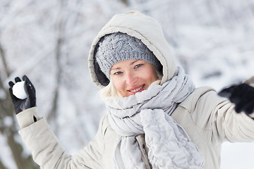 Image showing Girl snowball fighting in winter time.