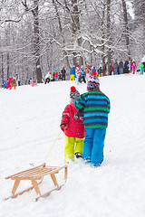 Image showing Winter fun, snow, children sledding at winter time.