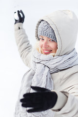 Image showing Girl snowball fighting in winter time.