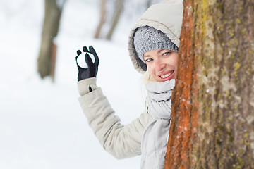 Image showing Girl snowball fighting in winter time.