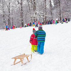 Image showing Winter fun, snow, children sledding at winter time.