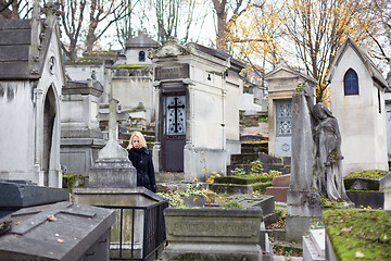 Image showing Solitary woman visiting relatives grave.
