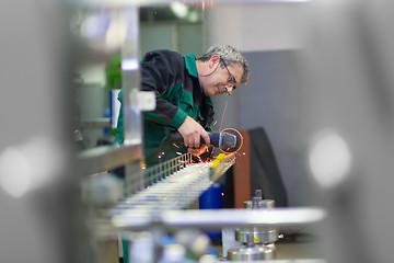 Image showing Industrial worker  grinding in manufacturing plant.