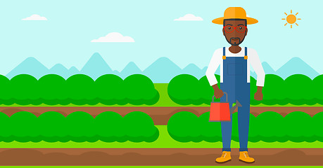 Image showing Farmer with watering can.