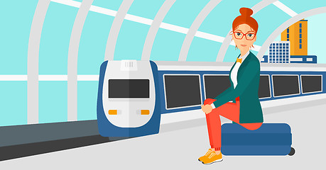 Image showing Woman sitting on railway platform.