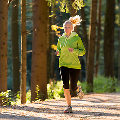 Image showing Pretty young girl runner in the forest. 