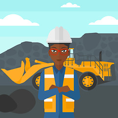 Image showing Miner with mining equipment on background.