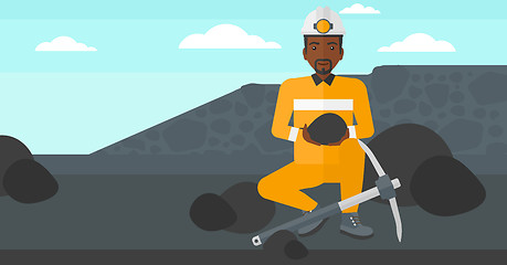 Image showing Miner holding coal in hands.