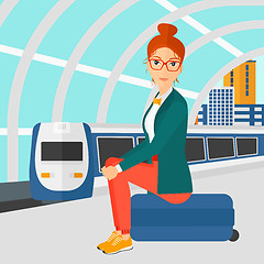 Image showing Woman sitting on railway platform.