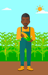 Image showing Farmer holding corn.