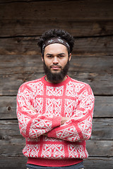 Image showing portrait of young hipster in front of wooden house