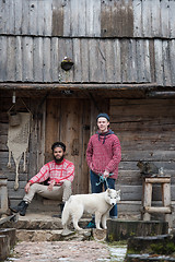 Image showing frineds together in front of old wooden house