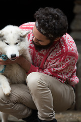 Image showing hipster with dog in front of wooden house