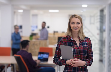 Image showing portrait of young business woman at office with team in backgrou