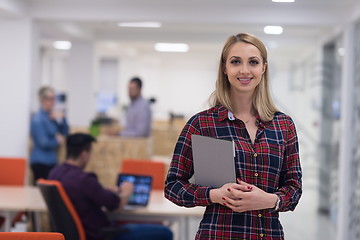 Image showing portrait of young business woman at office with team in backgrou