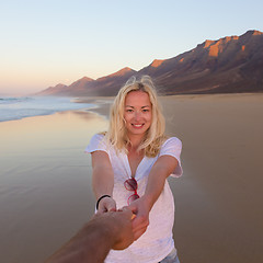 Image showing Romantic couple, holding hands, having fun on beach.