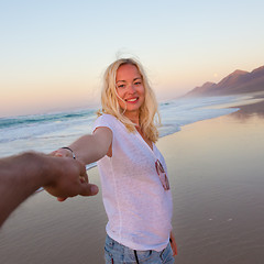 Image showing Romantic couple, holding hands, having fun on beach.