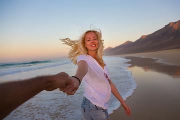 Image showing Romantic couple, holding hands, having fun on beach.