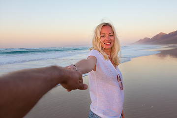 Image showing Romantic couple, holding hands, having fun on beach.