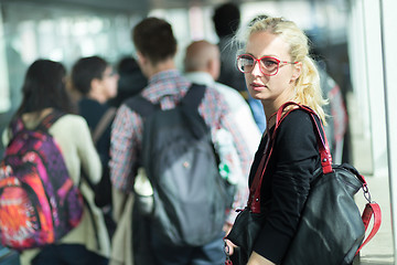 Image showing Young blond caucsian woman waiting in line.