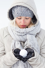 Image showing Girl  holding snowball in cold winter time.