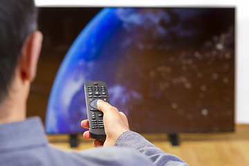 Image showing Man sitting on a sofa watching tv 