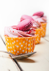Image showing pink berry cream cupcake with macaroon on top