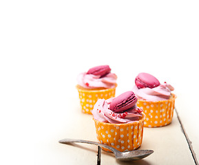 Image showing pink berry cream cupcake with macaroon on top