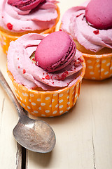 Image showing pink berry cream cupcake with macaroon on top