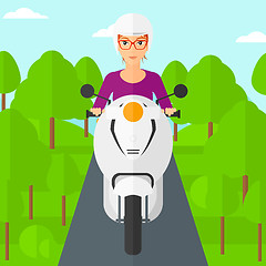 Image showing Woman riding scooter.