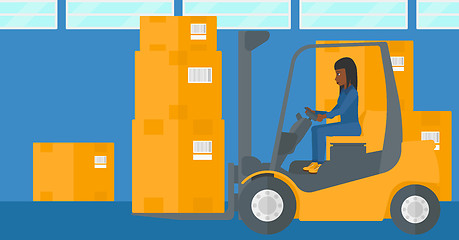 Image showing Warehouse worker moving load by forklift truck.