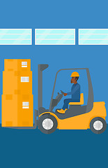 Image showing Warehouse worker moving load by forklift truck.