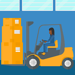 Image showing Warehouse worker moving load by forklift truck.