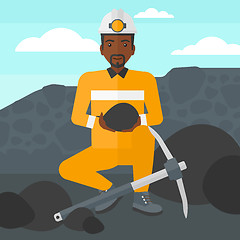 Image showing Miner holding coal in hands.