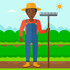 Image showing Farmer with rake.