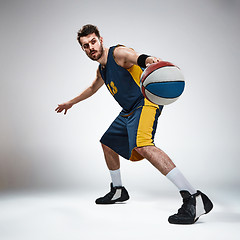 Image showing Full length portrait of a basketball player with ball 