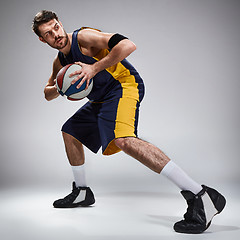 Image showing Full length portrait of a basketball player with ball 