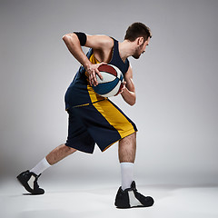 Image showing Full length portrait of a basketball player with ball 