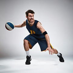 Image showing Full length portrait of a basketball player with ball 
