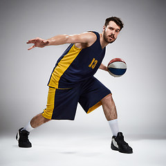 Image showing Full length portrait of a basketball player with ball 